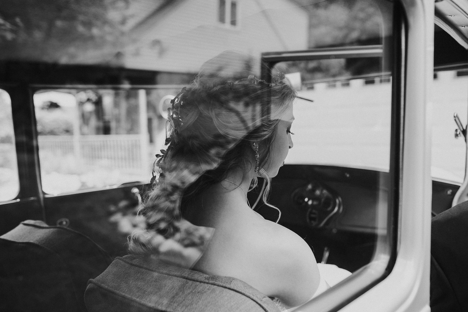 Bride seen through the window of a vintage car