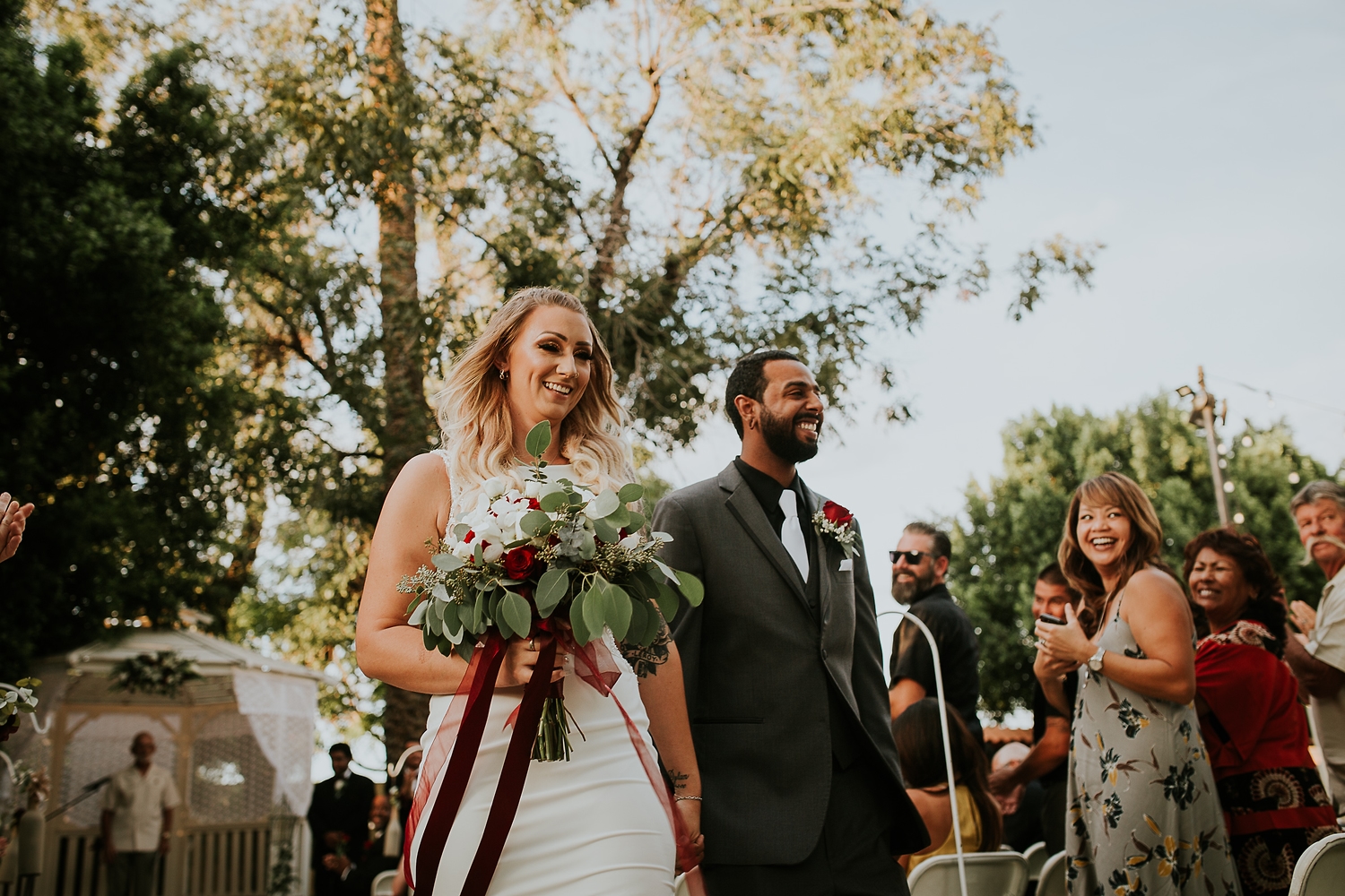 Couple laughing as guests cheer after the ceremony