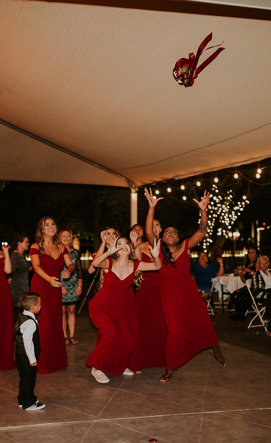 Bridesmaids dancing under the reception tent