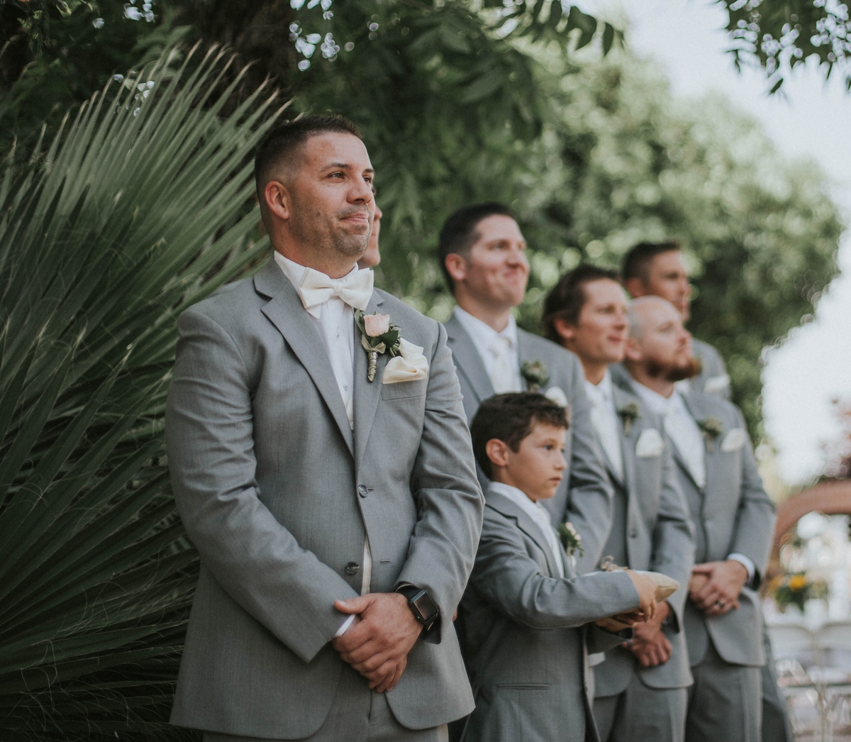 Groomsmen watching the bride arrive