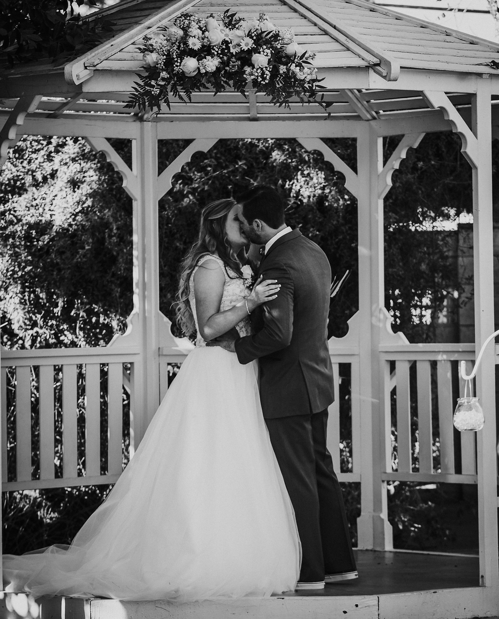 Couple kissing in a white gazebo